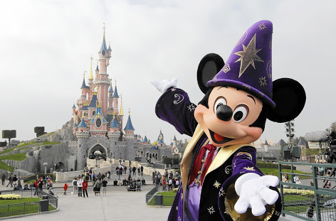 (FILES) - A file photo taken on March 31, 2012 shows Disney character Mickey posing in front of the Sleeping Beauty Castle at Disneyland park as part of the 20th birthday celebrations of the park, in Chessy, near Marne-la-Vallee, outside Paris. Euro Disney, which runs Disneyland Paris, a top European tourist attraction, announced on October 6, 2014 it was receiving a one-billion-euro refinancing package to overcome a crisis after a sharp fall in visitor numbers and spending. Shares in the company plunged by nearly 12.0 percent in initial trading in Paris. The plan includes a cash infusion of 420 million euros ($526 million) by the parent company, US-based Walt Disney Co, and a conversion of 600 million euros of debt owed to Walt Disney into equity, the company said in a statement. AFP PHOTO / THOMAS SAMSONTHOMAS SAMSON/AFP/Getty Images ** OUTS - ELSENT, FPG - OUTS * NM, PH, VA if sourced by CT, LA or MoD **